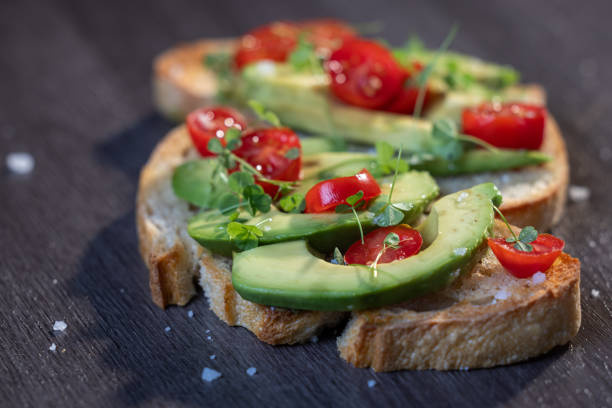 istock avocado toast topped with tomato and sprouts 2161641628