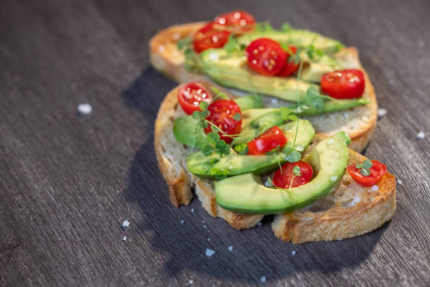 istock avocado toast topped with tomato and sprouts 2161641702