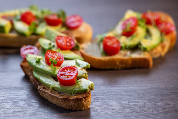 istock avocado toast topped with tomato and sprouts 2161642036