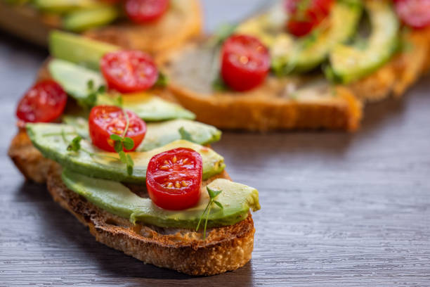 istock avocado toast topped with tomato and sprouts 2161642095