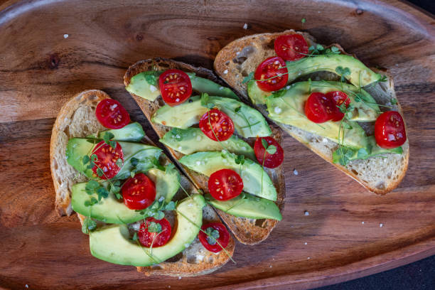 istock avocado toast topped with tomato and sprouts 2161643578