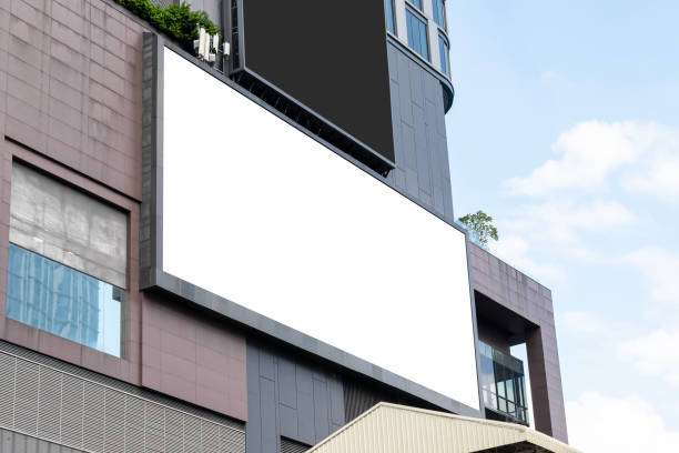 istock Mock up white large horizontal LED display billboard on tower building with blue sky background .clipping path for mockup 2161643849