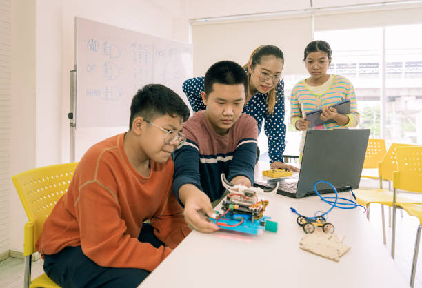 istock Primary education Students and friends learning Robotics technology in classroom with teacher 2161643889