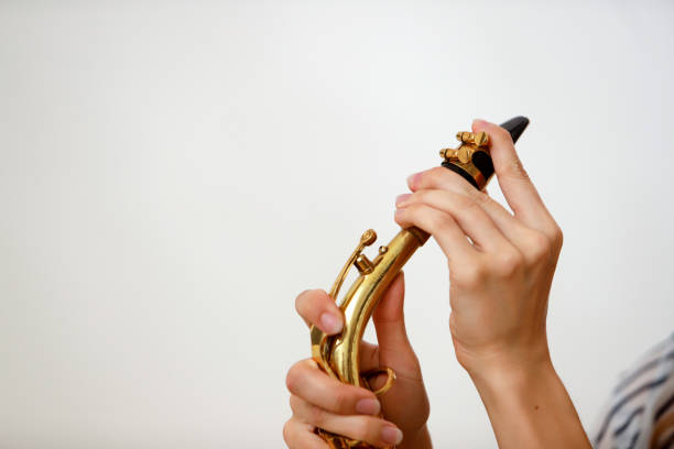 girl's hands putting saxophone mouthpiece