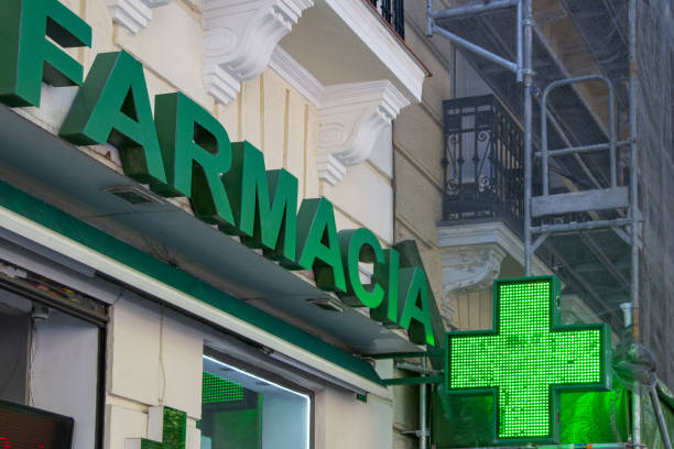 istock Pharmacy indication sign, a luminous green cross that indicates that a pharmacy is open and providing service. 2161650720
