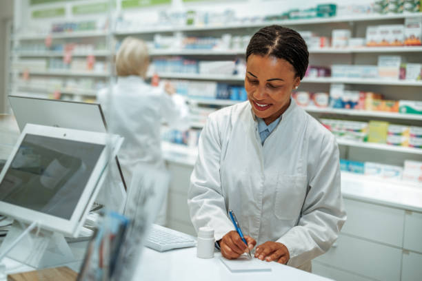 istock Smiling female pharmacist working at pharmacy store 2161650925
