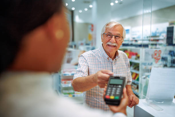 istock Senior man paying with credit card at pharmacy store 2161651158