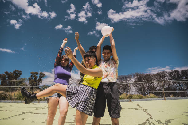 istock Friends playing with balloon in a public park 2161652794