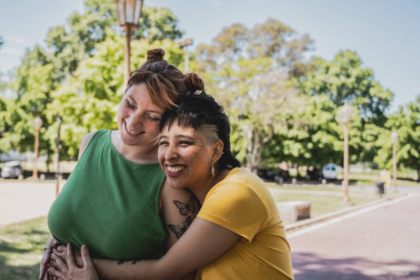 istock Lesbian couple embracing in a public park 2161652854