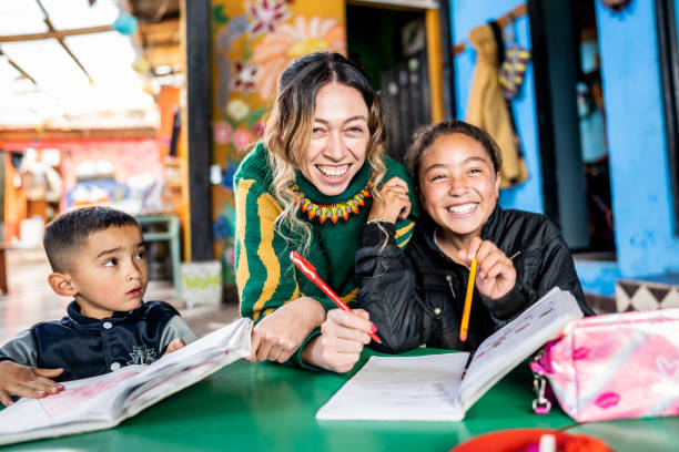 istock Teacher assisting students in the classroom at a children's foundation 2161654565