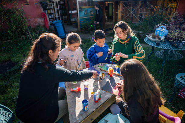 Teachers and students doing painting activity at children's foundation