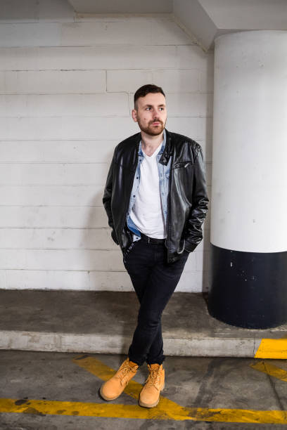 Handsome young man in a leather jacket outdoor