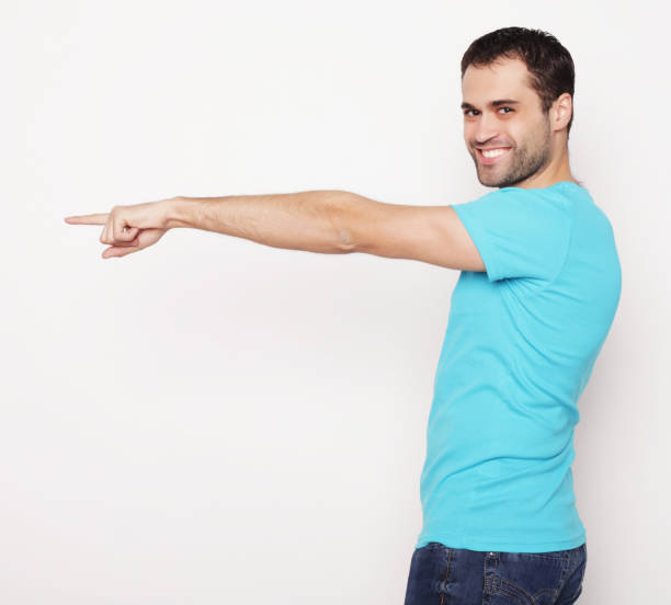 istock Young smiling happy man shows something 2161656442