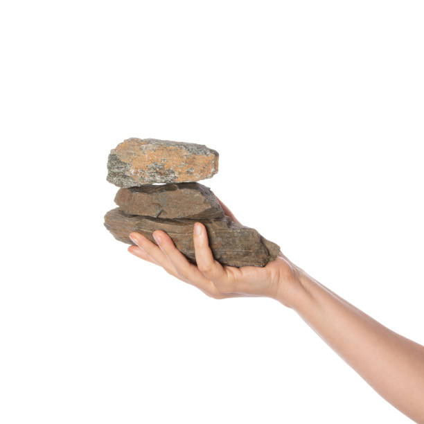 istock Hand holds stones isolated on white background. Textured rocks. Metaphor for balans and sturdiness. 2161657950