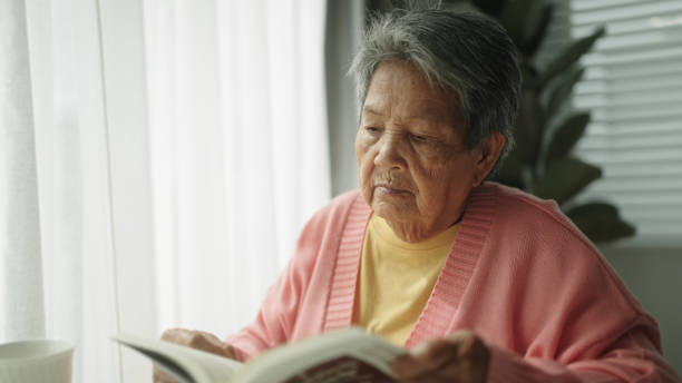 istock Senior woman reading a book. 2161658598