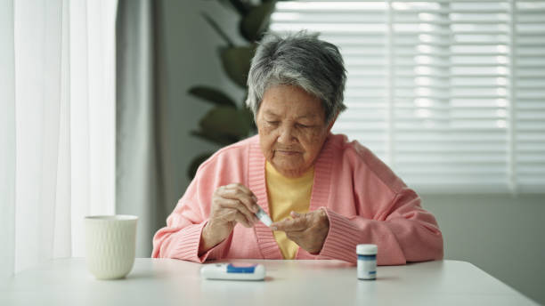 istock Elderly patient with diabetes using blood glucose meter. 2161658691