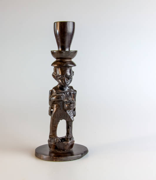 istock African figurine candlestick made of ebony on a white background. 2161659903