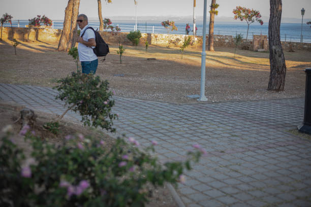 An elderly tourist explores a seaside tourist destination