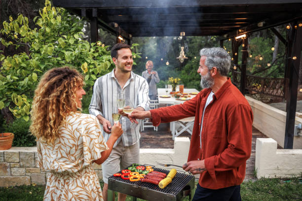 istock Friends having celebratory toast while making barbecue at the backyard 2161660583