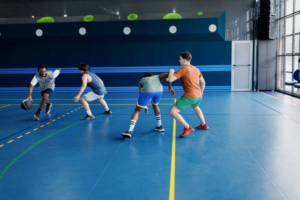 istock A friendly match between multiracial friends playing basketball indoors 2161662233