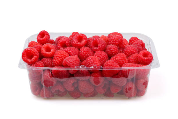 istock Large fresh raspberries in a transparent tray isolated on a white background 2161667759