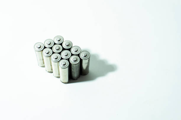 A bunch of unbranded AA alkaline batteries on a white background