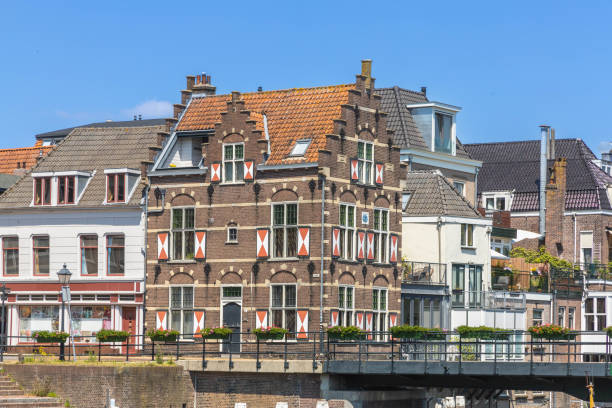 Gorinchem, the Netherlands. 25 June 2024. Typical houses with red and white shutters on the window in the fortified city Gorinchem along the bridge and canal Linge.