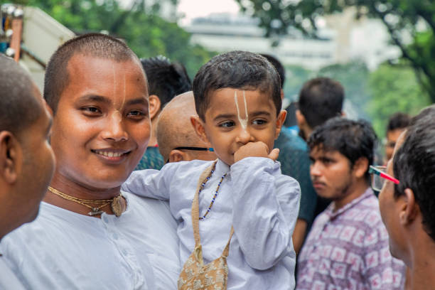 7th july 2024 kolkata west bengal india :International Society for Krishna Consciousness ISKCON celebrate Jagannath Rath Yatra, on July 7th, 2024 in Kolkata, India. A candid father and child portrait taken in this period.
