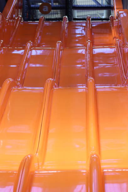 A large orange slide in a children's play park.