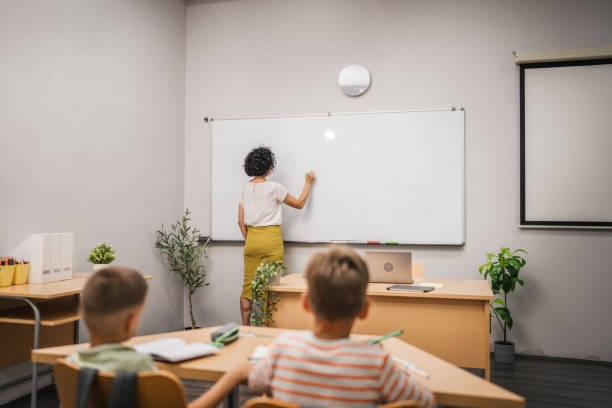 istock Mature teacher write lesson on board on school class in the classroom 2161673398