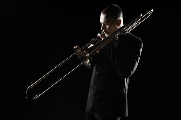 istock Trombone player. Trombonist playing brass instrument. Classical musician 2161674159