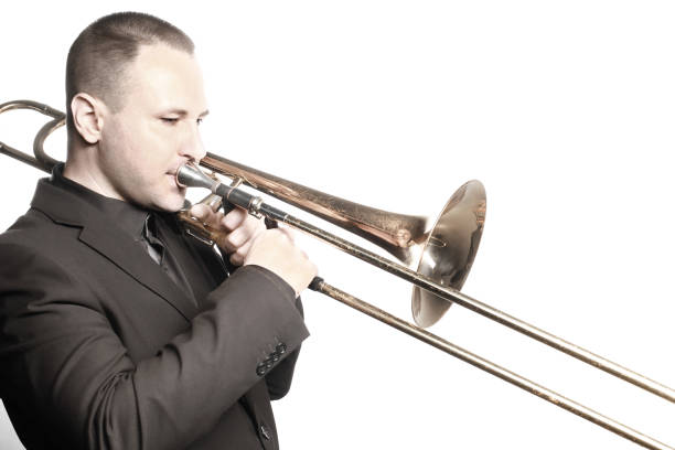 istock Trombone player. Trombonist playing brass instrument isolated on white 2161674769