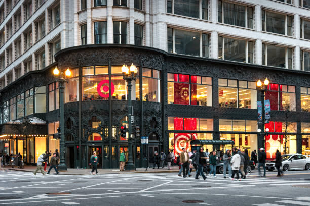 People walk past the City Target store, located in a historic building from 1899, on State Street, downtown Chicago, Illinois, USA in the evening. The building was designed by Louis Sullivan and it is clad floor-to-ceiling with cast-iron scrollwork and terra cotta facades.