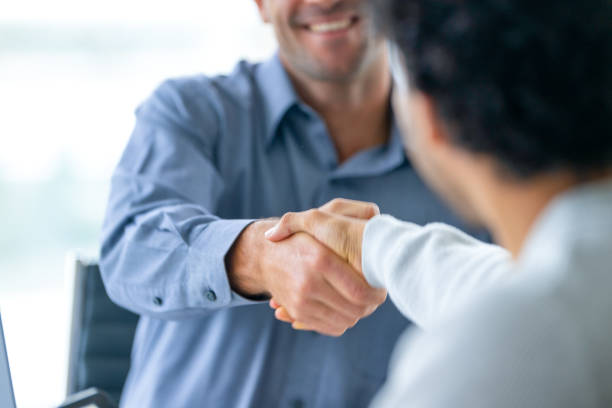 istock Two businessmen working shaking hands closing the deal. 2161678267
