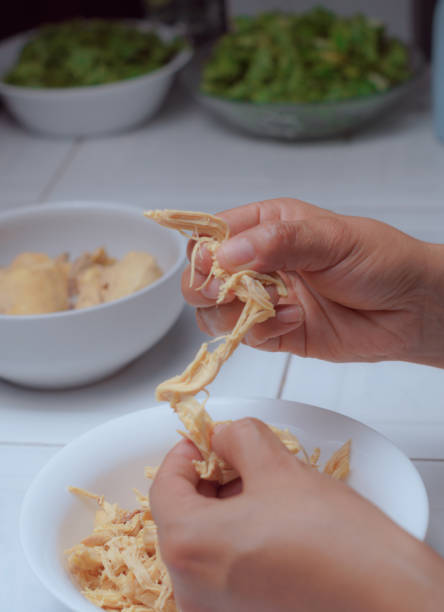 istock Hands of a chef preparing boiled chicken, shredding chicken 2161678326