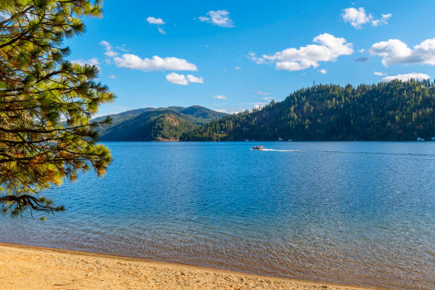 istock A boat passes in front of a small sandy beach at Beacon Point, a stop on the Centennial Trail, on lake Coeur d'Alene's Wolf Lodge Bay, in Coeur d'Alene, Idaho, USA. 2161680401