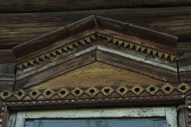 Close-up photo of an old wooden platband on an old willage house