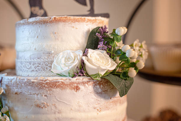 istock Naked Cake wedding with white roses decor close up 2161682867