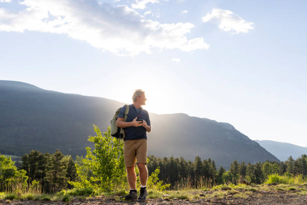 istock Senior hiker looks over shoulder 2161684854