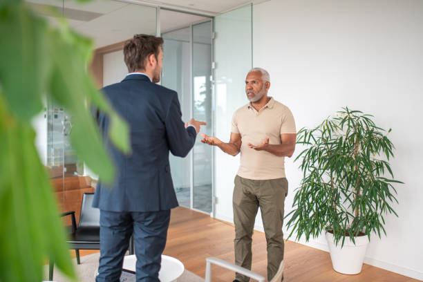 istock Senior Hispanic Man Greeted by Financial Advisor in Modern Office 2161685001