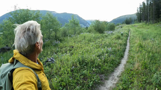 istock Senior man hikes pathway in mountains 2161686486