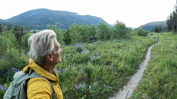 istock Senior man hikes pathway in mountains 2161686487