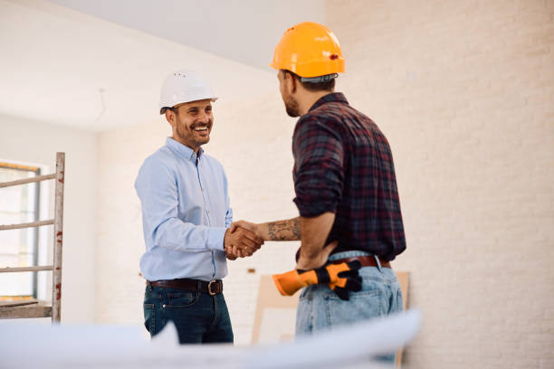 istock Happy building contractor shaking hands with a worker at construction site. 2161686849