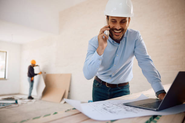 istock Happy architect talking on mobile phone at construction site. 2161686852