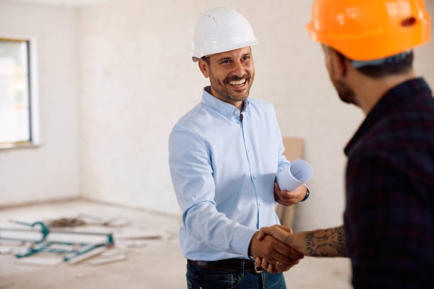 istock Happy architect and construction worker shaking hands during house remodeling project. 2161686853