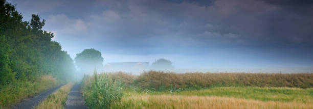 Weather front coming over huge lake in the morning with beautiful fog in the forground