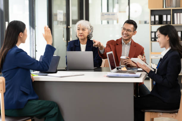istock Asian Workshop Participant Team Building in Small Group Discussions Brainstorming during classes, business workshops, giving advice, explaining the terms of the contract for doing business together. 2161689687