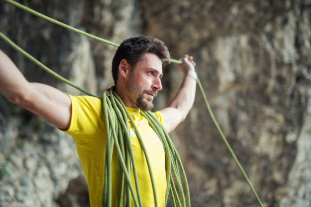Safety, security and mountain climbing rope knot for helping on outdoor or outside strong rock challenge fall risk danger. Fitness, exercise and training equipment gear for workout or wall adventure