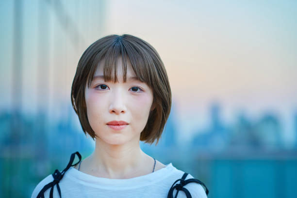 Portrait of a young woman standing in the city during magic hour