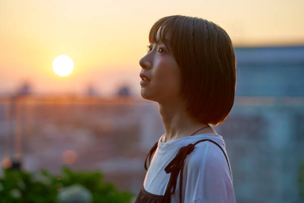 istock a young woman standing in the city during magic hour 2161693369